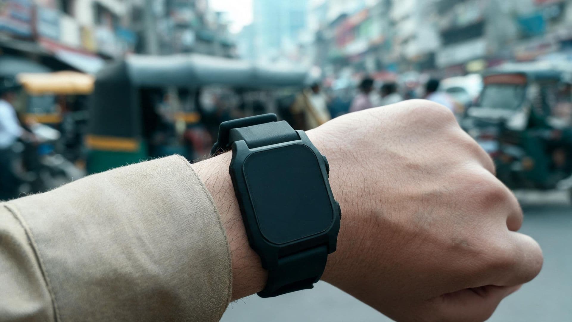 Illustrative photo: a rugged smartwatch on the wrist of an officer in uniform